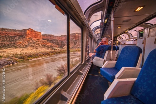 Amtrak Train crossing through the Colorado Rocky Mountains with peak Fall Colors in September photo