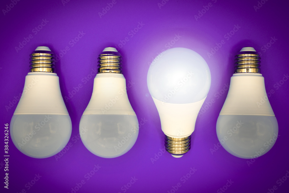 Successful idea, creativity and innovation concept. Lightbulbs upside down, one glows. Dark purple background with copy space Successful idea, creativity and innovation concept. Lightbulbs upside down, one glows. Dark purple background with copy space