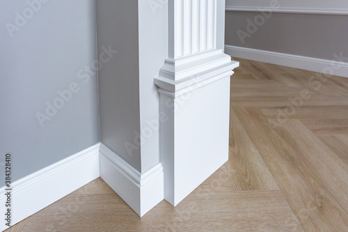 Detail of corner flooring with intricate crown molding.