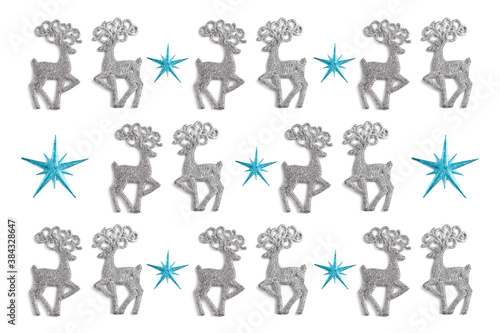 christmas pattern made of stars and silver color toys deer on white background. winter concept  flat lay  top view