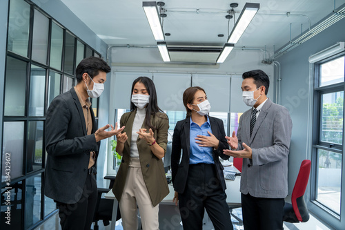 Group of business people wear mask for protect Covid-19 have a meeting and talking in the office.