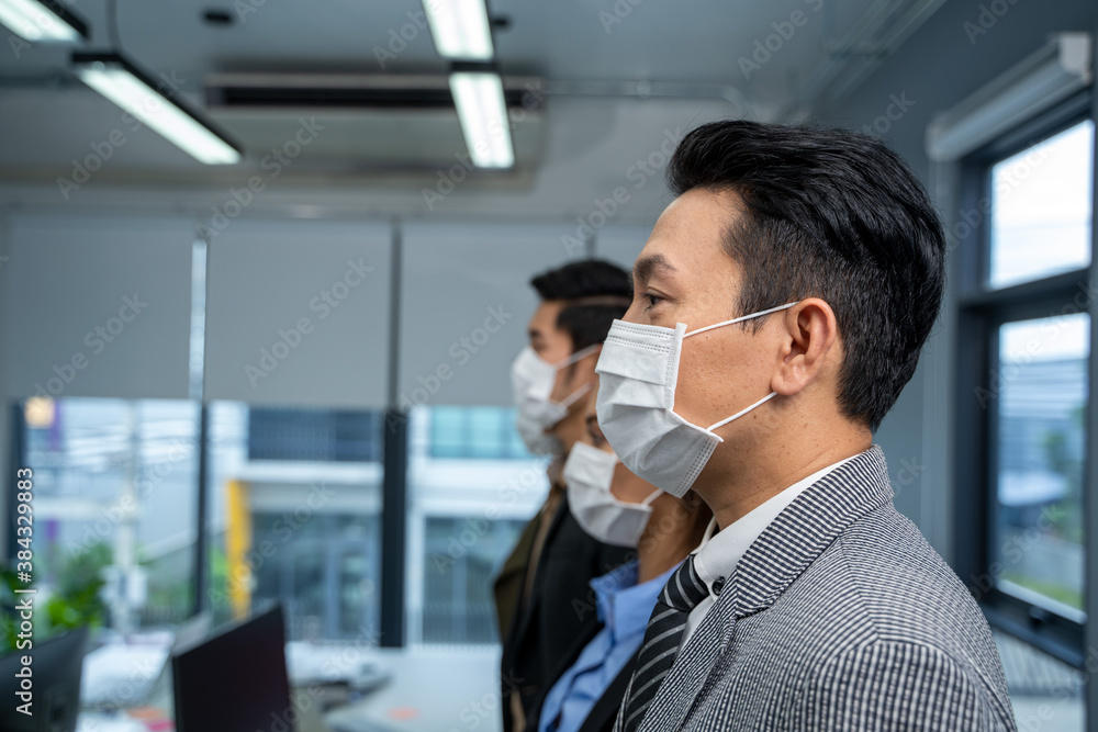 Close up portrait businessman wear mask for protect Covid-19 or corona virus disease at model office. Close up portrait businessman wear mask for protect Covid-19 or corona virus disease at model office.