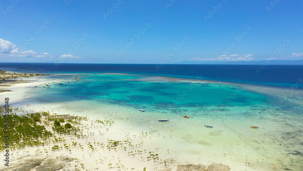 Aerial view of Lagoon with turquoise water and boats. Coral reef and Atoll with turquoise water and boats. Bohol,Philippines.