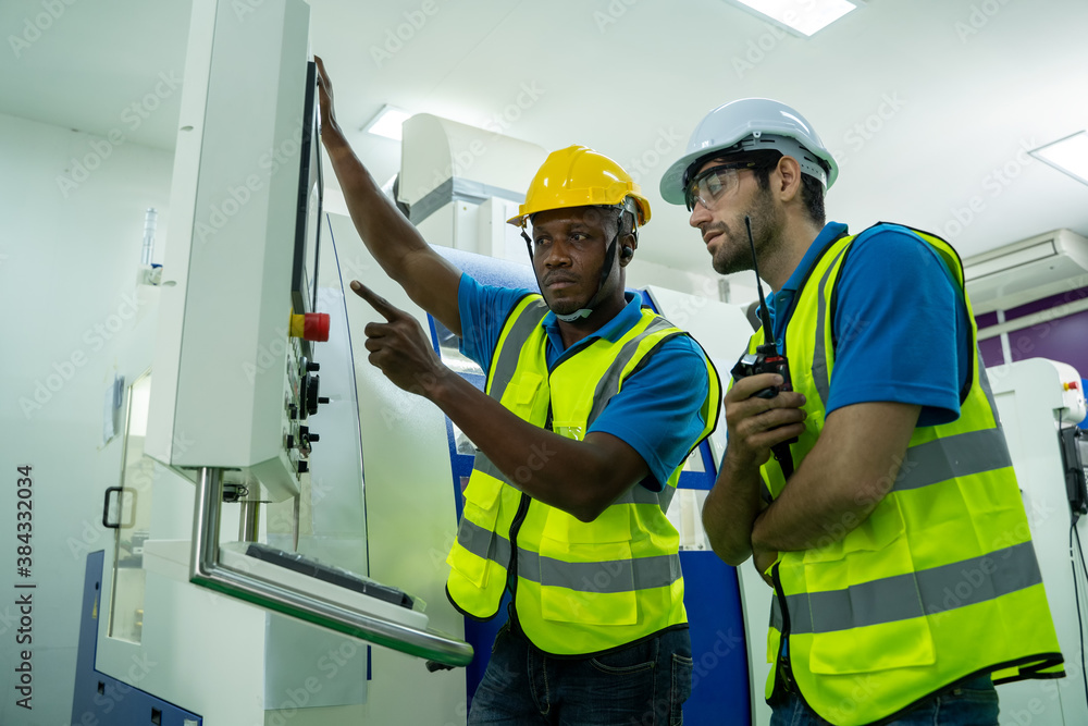 Engineer mechanic working and checking machine in a large industrial factory. Engineer mechanic working and checking machine in a large industrial factory.