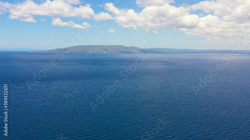 Cebu island and blue sea against the sky with clouds.