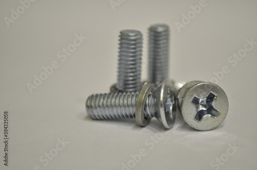 metal bolts with washers on a gray background