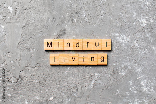mindful living word written on wood block. mindful living text on table, concept