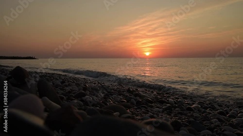 Amazing sunrise over the beach. Yellow golden sun over sea. Orange colors waves. Nature background. Beautiful  scene. Morning. Sunlight reflect on water surface
