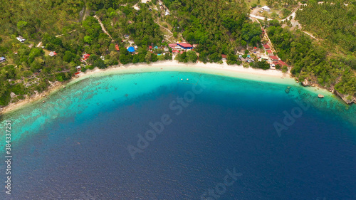 Beautiful beach Canibad  palm trees by turquoise water view from above. Philippines Samal island.