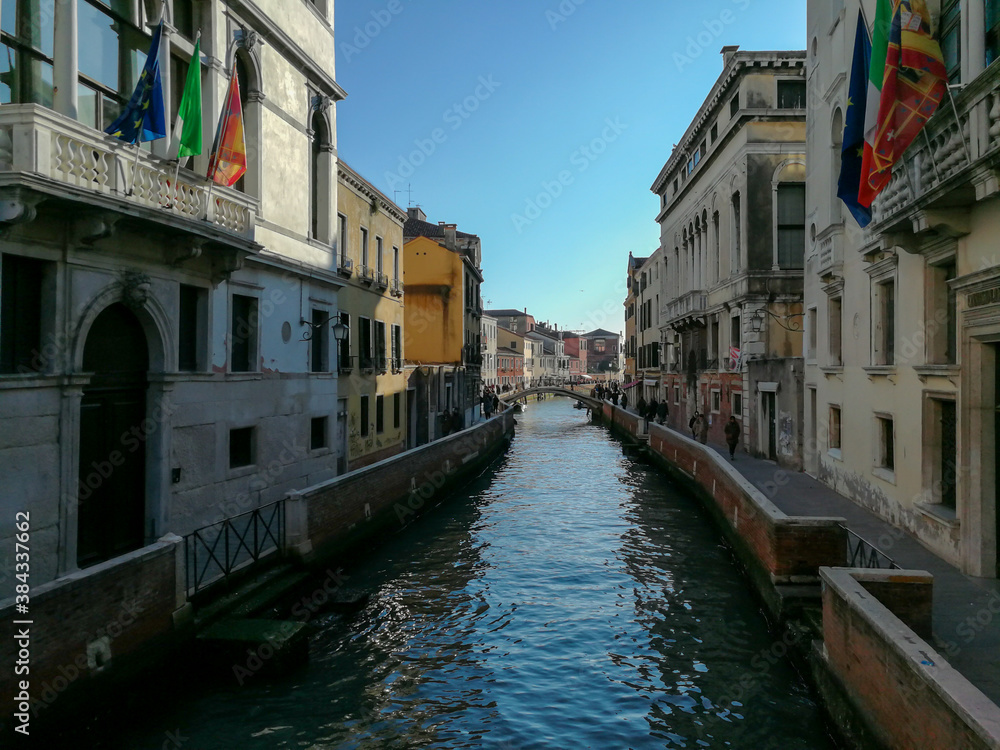 Pictures of Venice Canal in the summer with blue sky backdrop.  Traditional colorful houses 