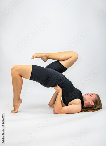 Fototapeta Naklejka Na Ścianę i Meble -  Beautiful girl hair engaged in yoga stretching fitness white background