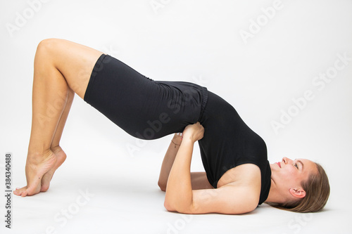 Beautiful girl hair engaged in yoga stretching fitness white background © dreamsnavigator