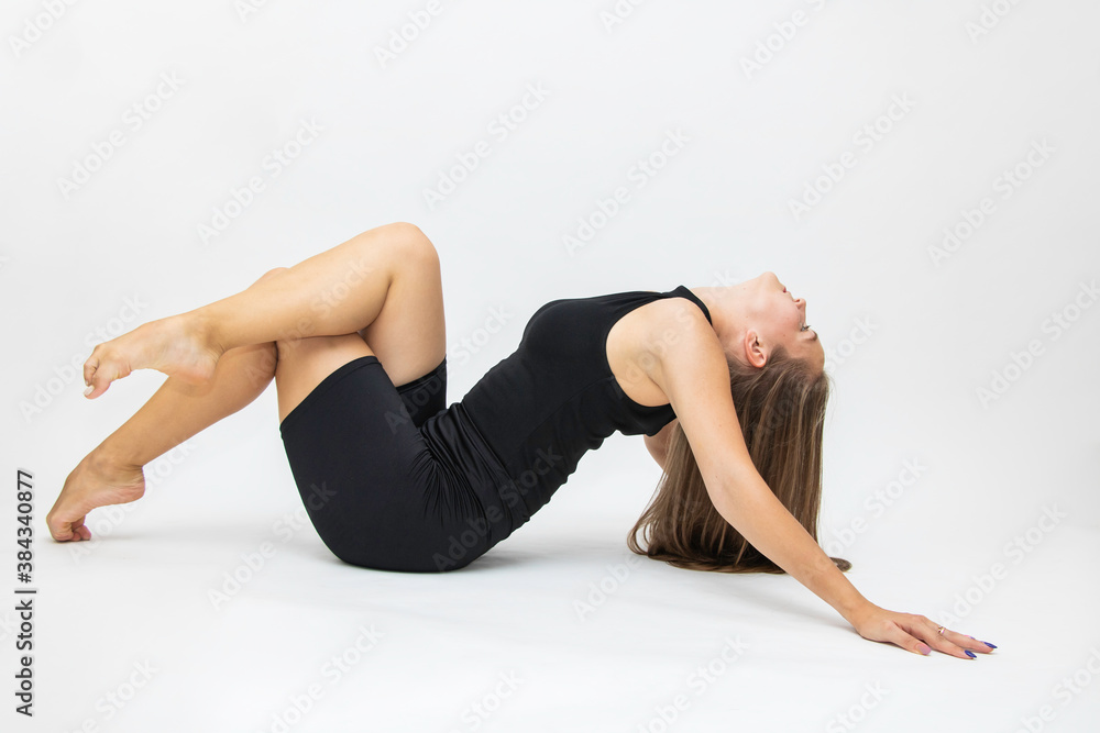 Beautiful girl hair engaged in yoga stretching fitness white background Beautiful girl hair engaged in yoga stretching fitness white background