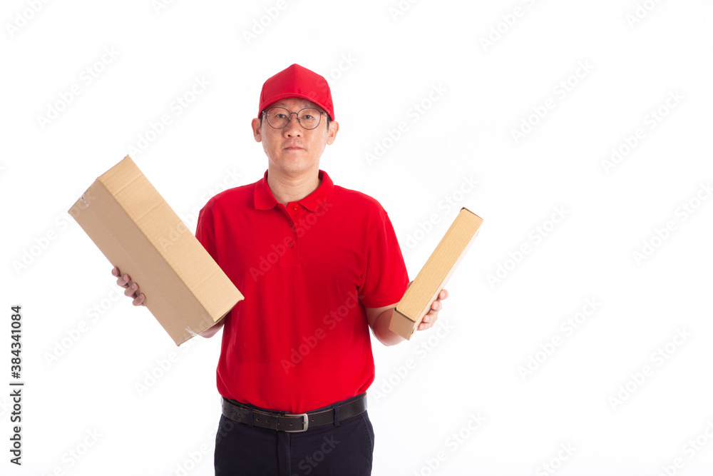 young Asian delivery man in red uniform, carry cardboard box in hands isolated on white background. young Asian delivery man in red uniform, carry cardboard box in hands isolated on white background.
