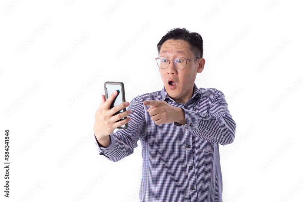 Surprised face of Asian man shocked what he see in the smartphone Surprised face of Asian man shocked what he see in the smartphone