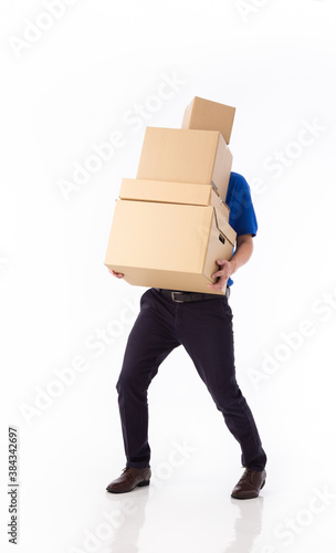 young Asian delivery man in blue uniform, carrry cardboard box in hands isolated on white background