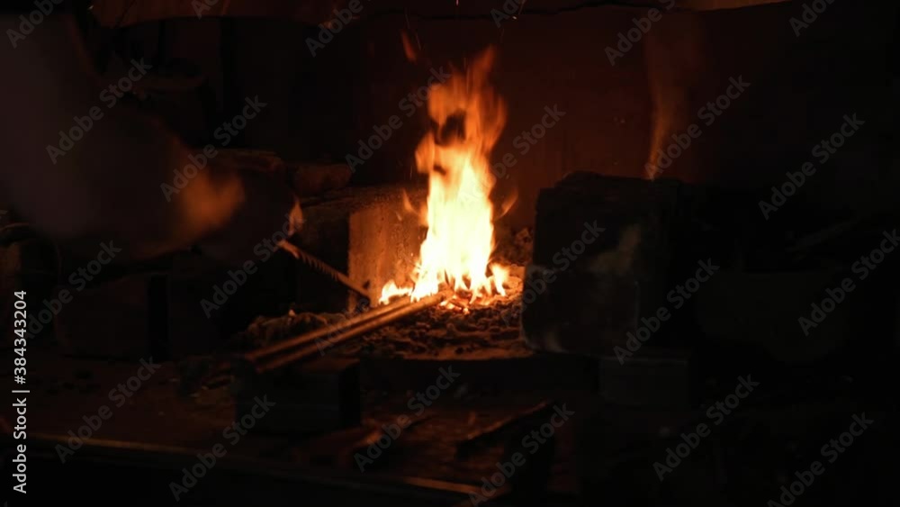 Burning flame forge. Blacksmith at work in the forge Burning flame forge. Blacksmith at work in the forge