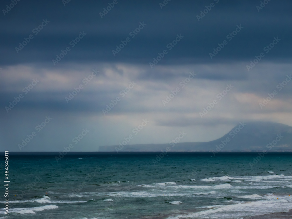 Cloudy seascape with the coast in the background