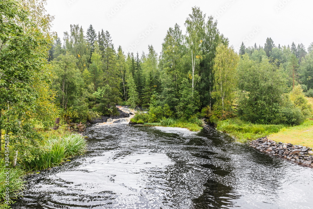 Park with the cascades of Akparhvenkoski waterfalls on the Tokhmayoki River, a popular tourist attraction situated near the settlement Ruskeala in Karelia, Russia Park with the cascades of Akparhvenkoski waterfalls on the Tokhmayoki River, a popular tourist attraction situated near the settlement Ruskeala in Karelia, Russia