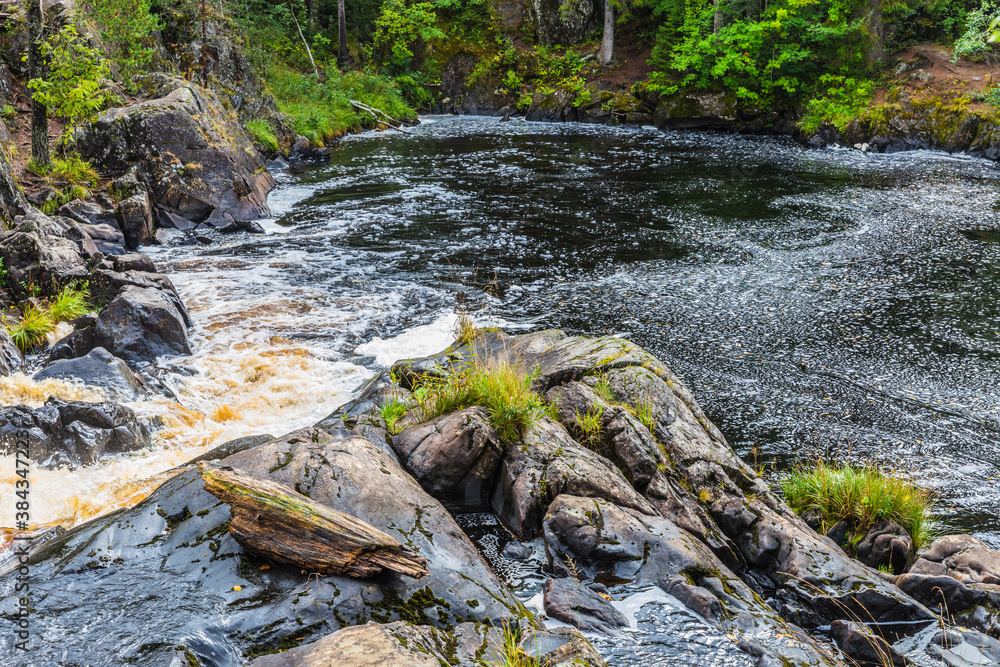 Fototapeta premium Park with the cascades of Akparhvenkoski waterfalls on the Tokhmayoki River, a popular tourist attraction situated near the settlement Ruskeala in Karelia, Russia