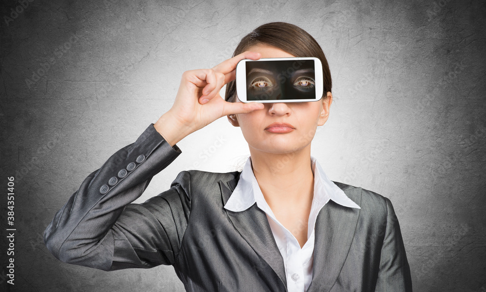 Woman covering her eyes with smartphone Woman covering her eyes with smartphone