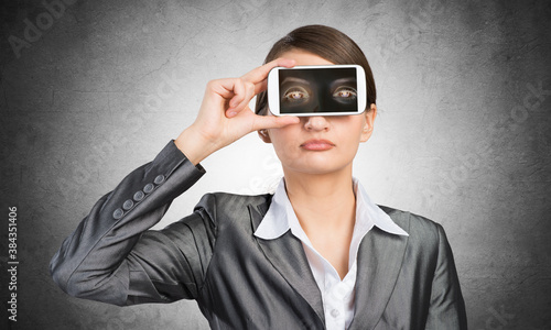 Woman covering her eyes with smartphone