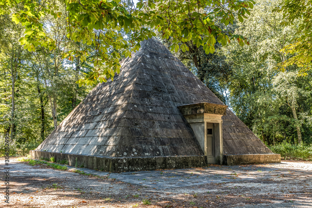 An old pyramid-shape ice house, building used to store ice throughout the year, in the monumental an historical Cascine park, Firenze, Tuscany region, Italy. An old pyramid-shape ice house, building used to store ice throughout the year, in the monumental an historical Cascine park, Firenze, Tuscany region, Italy.