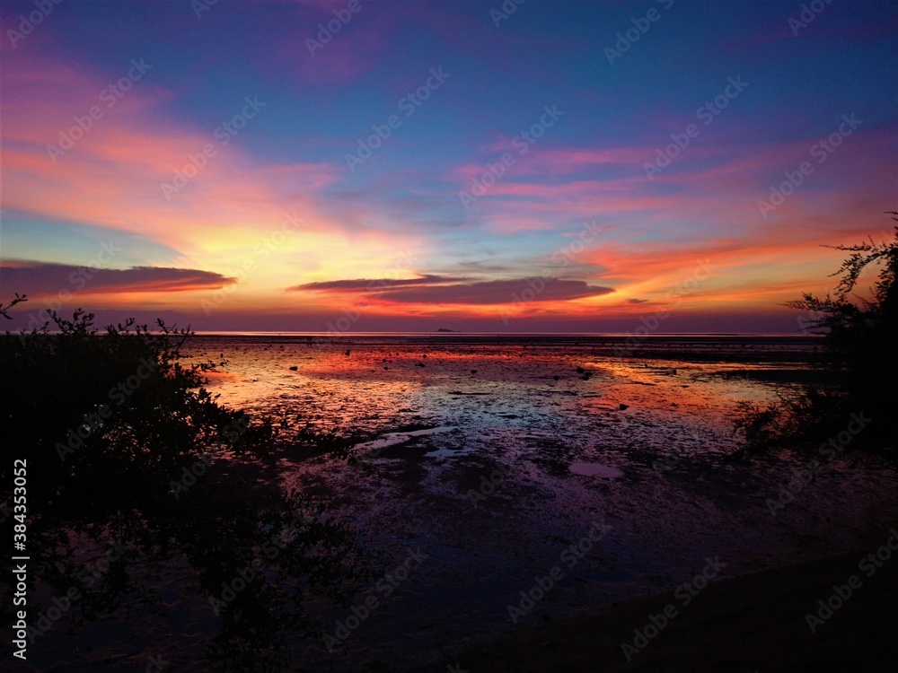 Colorful sunset over low tide