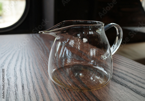 clear jug on wooden table photo