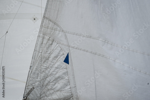 Close up of the stitches of a main sail and a jib photo