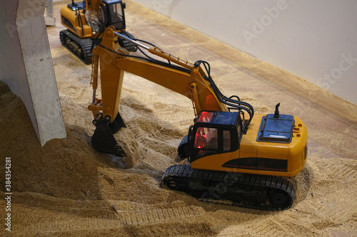 Toy collection of the construction site with trailers, excavators, truck and crane operated by remote control  
