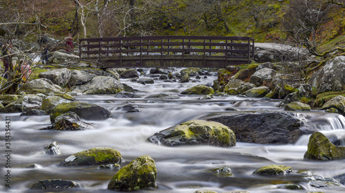 Flowing water under a small footbridge on the way to Aber Falls