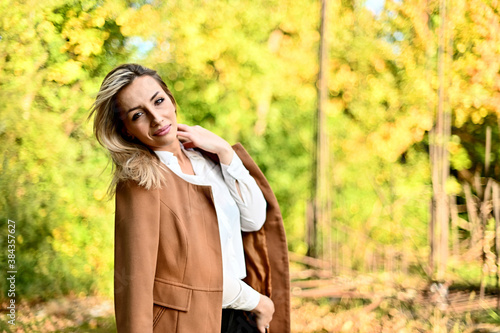 young woman in park on sunny autumn day 