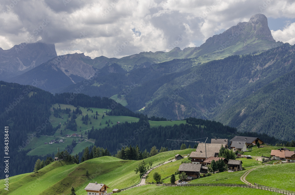 Armentara meadows and farms above La Val with Sass de Putia mountain, Alta Badia, Dolomites, South Tirol, Italy.