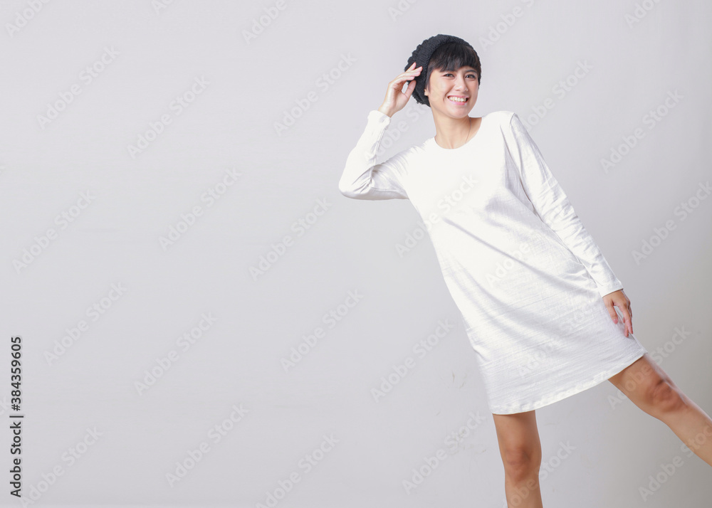 Young beautiful woman wearing white dress and beanie over light grey isolated background  smiling confident and happy gesture