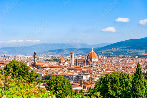 Scenic view of Florence from the Basilica of San Miniato al Monte, near Piazzale Michelangelo. Blue sky and vegetation; Tuscany region, Italy.