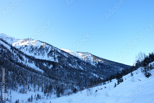 Winter landscape in the mountains of Lake Baikal. The Khamar-Daban mountain range. Abundant snow cover.
