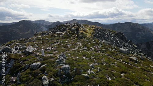 From Ground to Aerial Top Shot of Male Climber in the Summit of a Mountain. Asturias, Spain. Impressive Cinematic Drone Footage