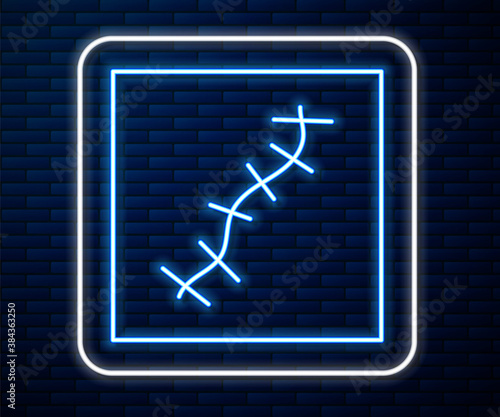 Glowing neon line Scar with suture icon isolated on brick wall background. Vector.
