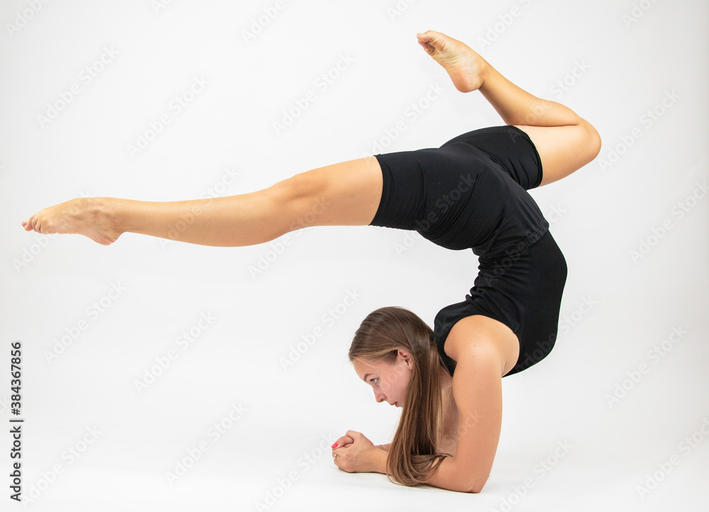 Beautiful girl hair engaged in yoga stretching fitness white background Beautiful girl hair engaged in yoga stretching fitness white background