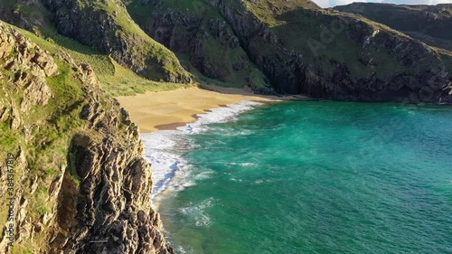 Boyeeghter Bay, commonly known as Murder Hole Beach, is one of the most beautiful beaches in Ireland situated on the Melmore Head Peninsula in County Donegal. Majestic Atlantic waves on sandy beaches photo