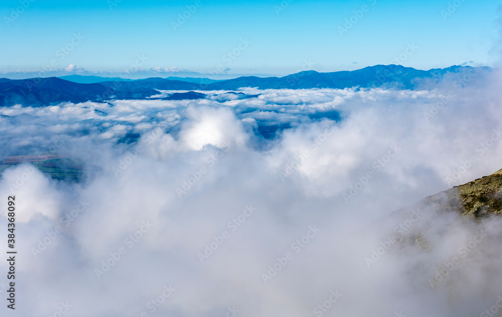 The so-called sea of clouds above the lowlands, and above them emerging mountain ranges.