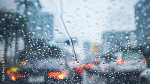 Photography driving car on road in the rain with raindrop over the wind shield, traffic jam