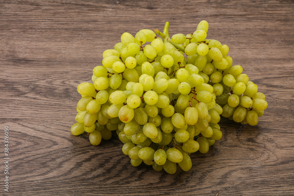 Green grape branch over background Green grape branch over background