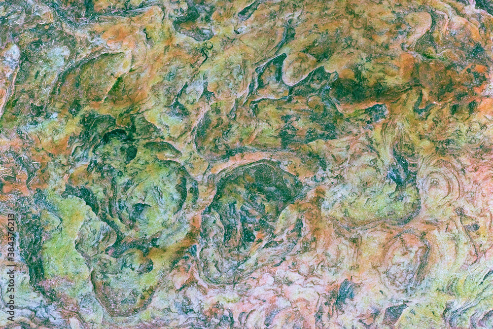 Green, orange, blue and yellow sedimentary rocks - colourful rock layers formed through cementation and deposition - abstract graphic design backgrounds, patterns, textures Green, orange, blue and yellow sedimentary rocks - colourful rock layers formed through cementation and deposition - abstract graphic design backgrounds, patterns, textures