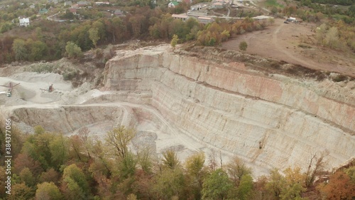 Lime quarry. A quarry where excavators extract limestone.