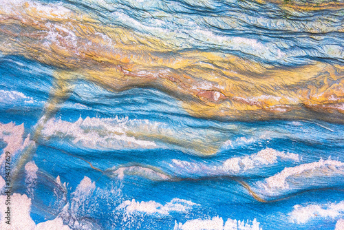 Rock layers - a colorful formations of sedimentary rocks stacked over the hundreds of years. Abstract background with fascinating texture for graphic design.