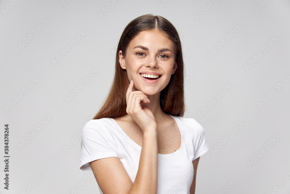 woman straightens her hair pretty brunette smile t-shirt woman straightens her hair pretty brunette smile t-shirt