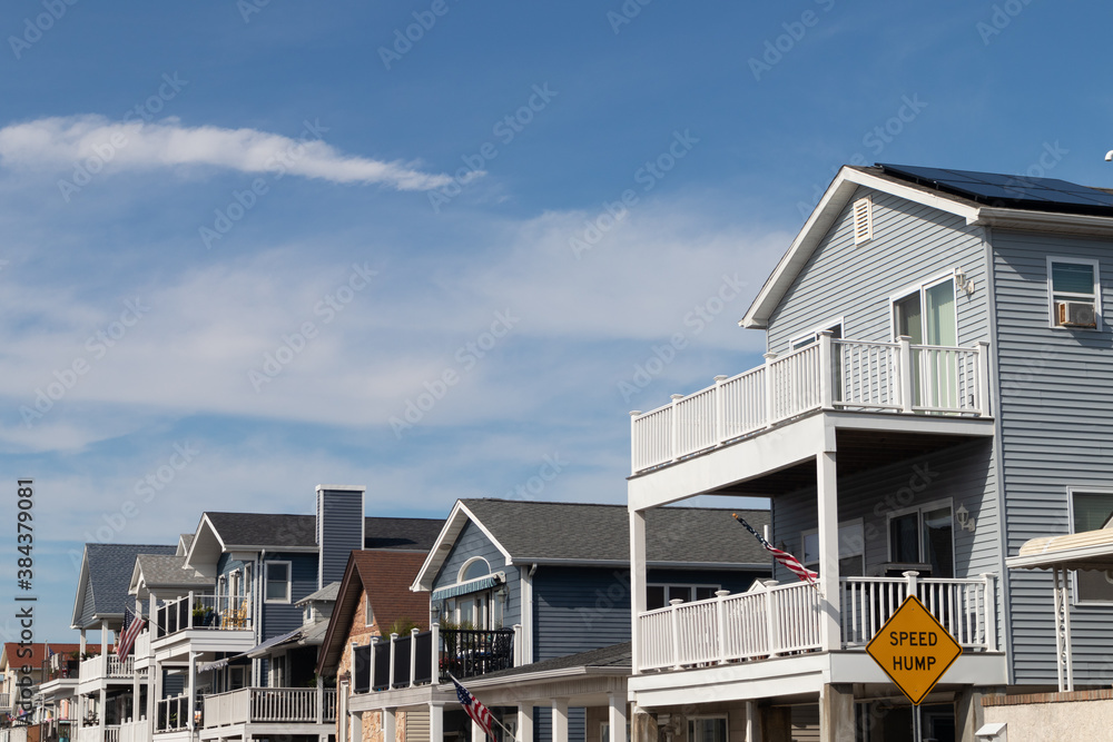 Row of White Wood Homes in Long Beach New York with American Flags