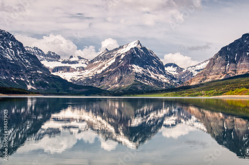 Fototapeta Naklejka Na Ścianę i Meble -  Mirrored Mountains and Clouds at Glacier National Park